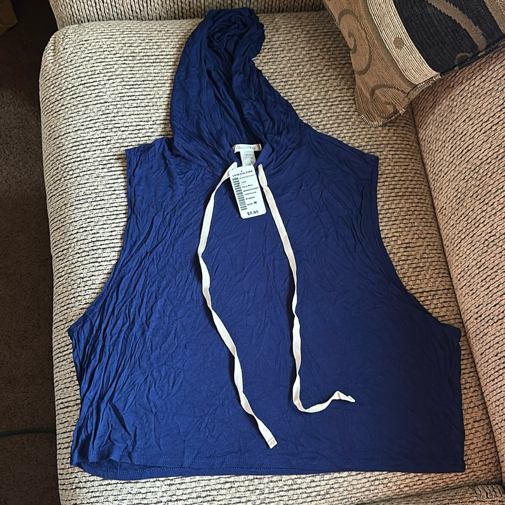 Hooded light muscle like shirt. Never worn with tag.